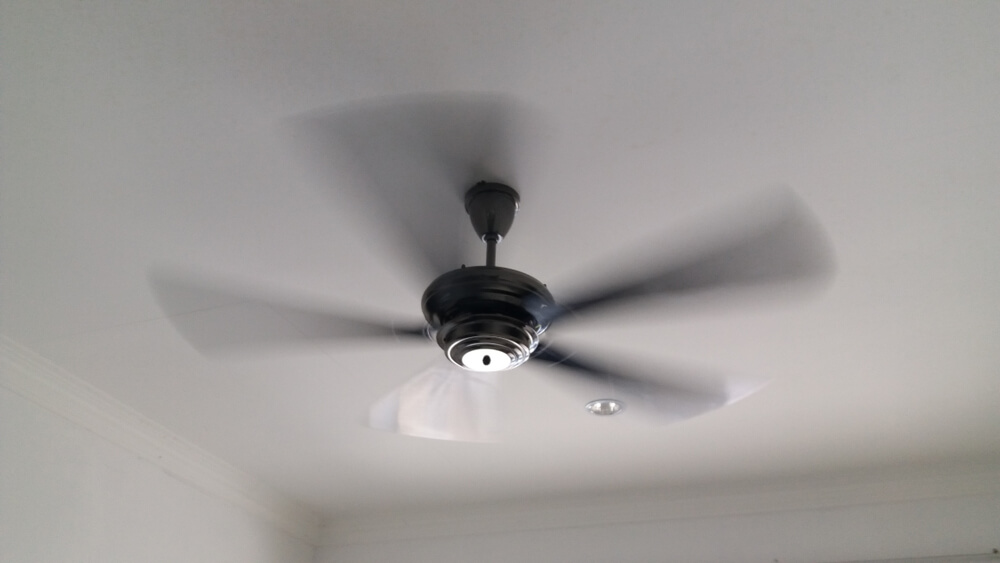 ceiling fan moving the air inside of bedroom
