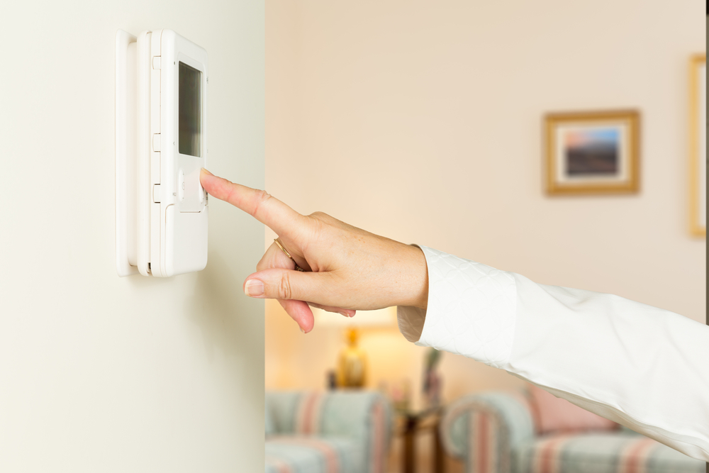 Person adjusts thermostat, controlling auxiliary heat